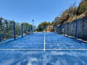 an empty tennis court with a fence on it at Elpida Village in Istro