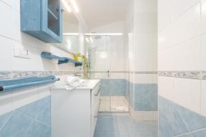 a bathroom with a sink and a shower at Alloggio Poseidone in Villasimius +22 photos