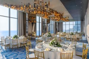 a dining room with tables and chairs and a chandelier at Amari Colombo, Sri Lanka in Colombo +99 photos