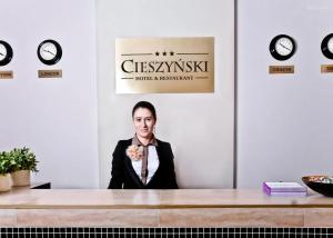 a woman sitting at a desk in a room at Cieszyński by Imperis Hotels in Cieszyn