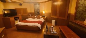 a hotel room with a bed and a couch at ホテル　ネグレスコ in Amagasaki +11 photos