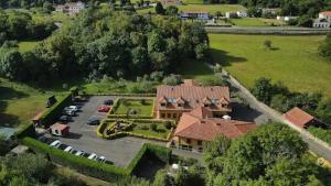 Luftaufnahme eines Hauses mit Parkplatz in der Unterkunft Hotel Pugide in Llanes