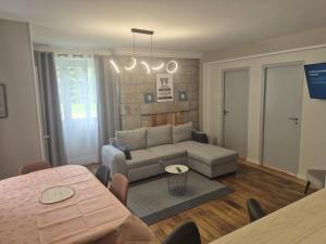 a living room with a couch and a table at Kergoat in Carhaix-Plouguer