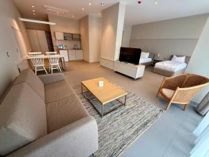 a living room with a couch and a table at Romance Hotel and Family Suites in Saints Constantine and Helena