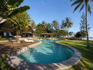 a swimming pool at a resort with palm trees at Rekawa Reach Tangalle in Tangalle