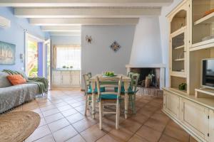 a living room with a table and a couch at Alloggio Poseidone in Villasimius