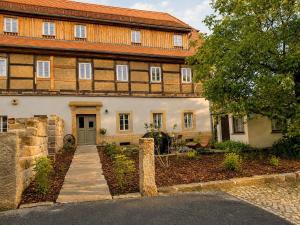 a large house with a pathway leading to it at Gutshof 1600 in Hohnstein +18 photos