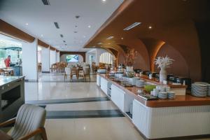 a restaurant with a counter with dishes on it at Omar Hotel in Tangerang