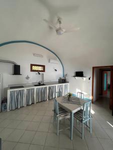 a kitchen with a table and chairs in a room at Melania Home II in Filicudi