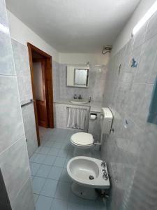 a small bathroom with a toilet and a sink at Melania Home II in Filicudi +20 photos