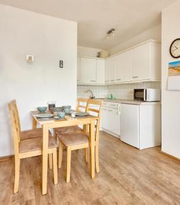 a kitchen and dining room with a table and chairs at Elbe I, Ferienwohnung 29 in Cuxhaven