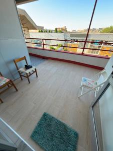 a balcony on a cruise ship with a chair and a rug at CR BnB Rozzano 2 in Rozzano