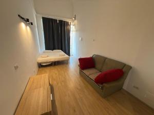 a living room with a couch and a table at CR BnB Rozzano 2 in Rozzano