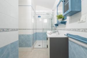 a bathroom with a sink and a shower at Alloggio Nettuno in Villasimius +28 photos