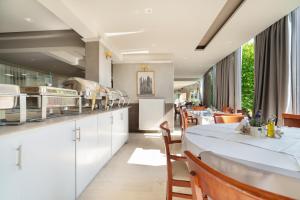 a restaurant with white counters and tables and chairs at Pigasos in Nikiana