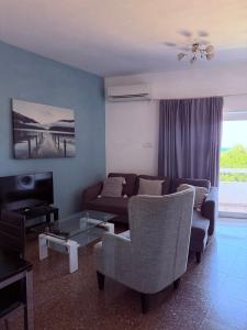 a living room with a couch and a table at GA apartments in Kato Pyrgos