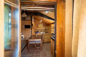 a kitchen with a wooden table and a dining room at Sons do Eo- Apartamentos rurales sostenibles en Baleira Lugo in Baleira