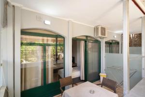 a dining room with green and white walls and a table and chairs at Pigasos in Nikiana +153 photos