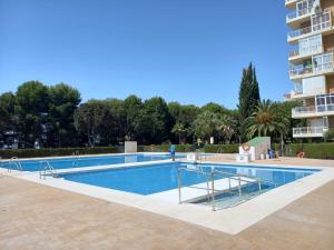 a swimming pool next to a apartment building at Iris Summer Beach in Benalmádena