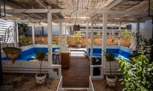 a patio with blue benches and potted plants at The Moon Vama Veche in Vama Veche