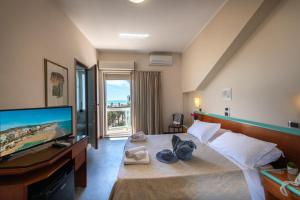 a hotel room with a bed with a flat screen tv at Hotel Soraya in San Benedetto del Tronto