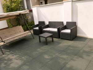 a patio with two chairs and a coffee table at Móra Apartman in Pécs