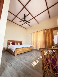 a bedroom with a large bed and a ceiling at Mountain Vibe Resort in Chamba