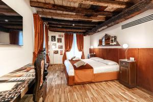 a bedroom with a bed and a wooden ceiling at Aurum Collection - Como Suites in Como