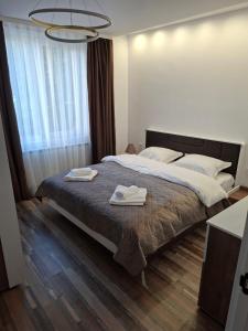 a bedroom with a large bed with two towels on it at Studio Niki in Smolyan