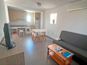 a living room with a couch and a table at Apartamentos Las Arenas 3000 in Alcossebre