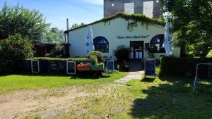 a white building with a sign in front of it at Ferienwohnung Sternenhimmel in Dranske