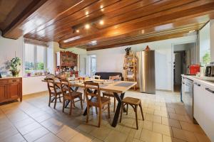 a kitchen with a table and chairs in a room at La Bourgerie in Saint-Aubin-des-Bois