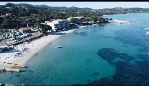 an aerial view of a beach and the ocean at Hôtel du Golfe Pinarello in Pinarellu +49 photos