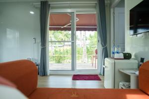 a living room with a door to a patio at Kood Friends Koh Kood in Ko Kood +32 photos