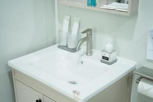 a bathroom sink with a faucet on a counter at Kood Friends Koh Kood in Ko Kood