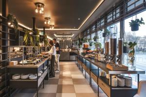 a restaurant with two people standing in front of a counter at master Wola in Warsaw