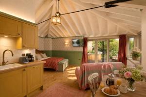 a kitchen and a living room with a bed at The Boathouse - Salcombe - Spring Time Tiny Home in Salcombe