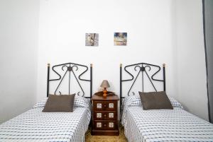 two beds sitting next to each other in a bedroom at Villa Mª José in Benicarló +18 photos