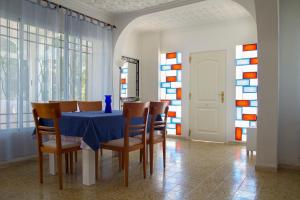 a dining room with a blue table and chairs at Villa Mª José in Benicarló