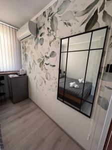 a bedroom with a mirror on the wall at Семейна къща “Вълчеви” in Kiten