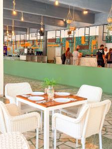 a table and chairs in a restaurant with a kitchen at Mojo Resort in Eforie Sud