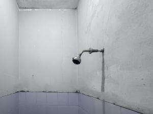 a corner of a bathroom with a shower at RedDoorz at Kuning GH Jatinangor in Sayang