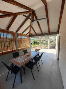 a dining room with a wooden table and chairs at Apartment Miljenko Tomić in Splitska
