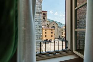 a window with a view of a church at Aurum Collection - Como Suites in Como