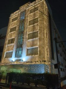 a tall building with christmas lights on it at Aditya Homes Gachibowli in Hyderabad