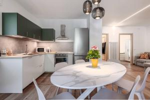 a kitchen with a table with a vase of flowers on it at Maison Bovet Appartements in Arvier