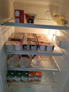 an open refrigerator filled with food and other food items at B&B Sikelia in Terrasini
