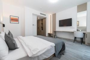 a bedroom with a bed and a flat screen tv at Dorana Toro Hotel in Kyrenia