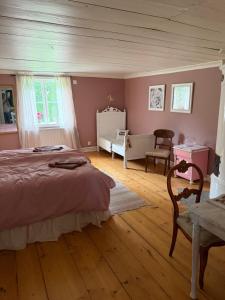 a bedroom with a bed and a table and chairs at Flishult gård in Vetlanda