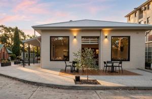 a small white house with a tree in front of it at ROMSEN Nambucca Valley in Macksville